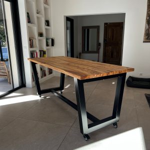 Table AIX en bois d'olivier massif et piètement industriel acier noir sur roulettes, design moderne sur mesure.